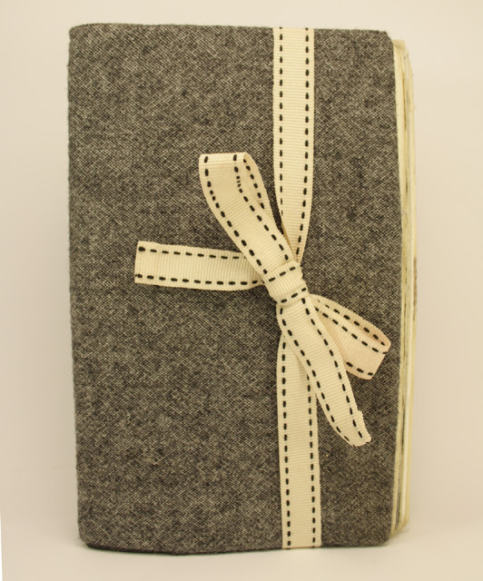 moleskine notebook covered in tweed trousers and ribbon